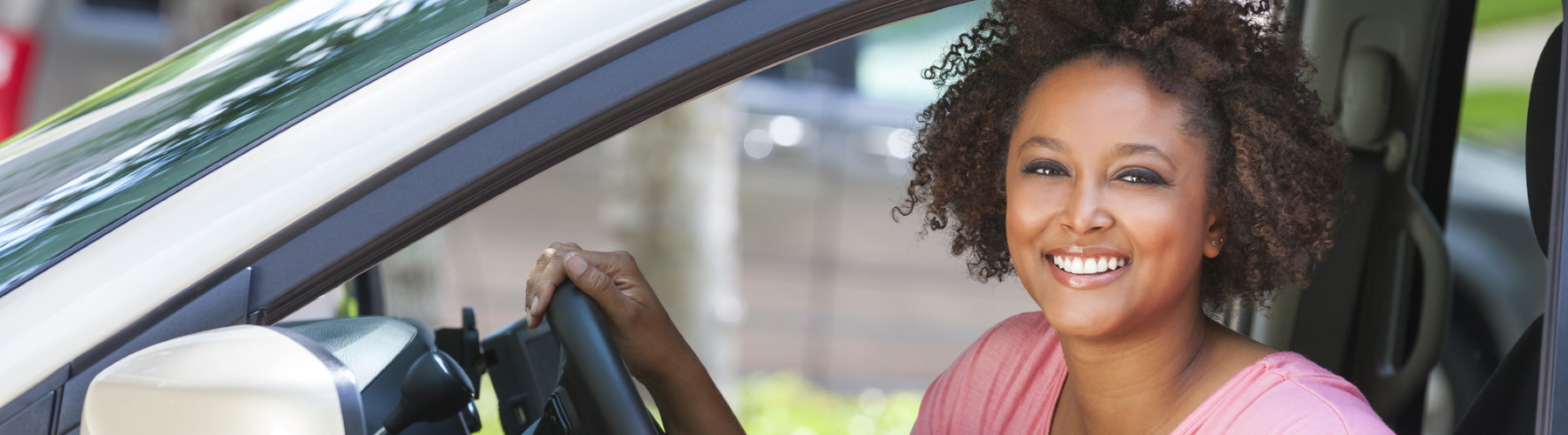 Auto insurance represented by a woman sitting in a car